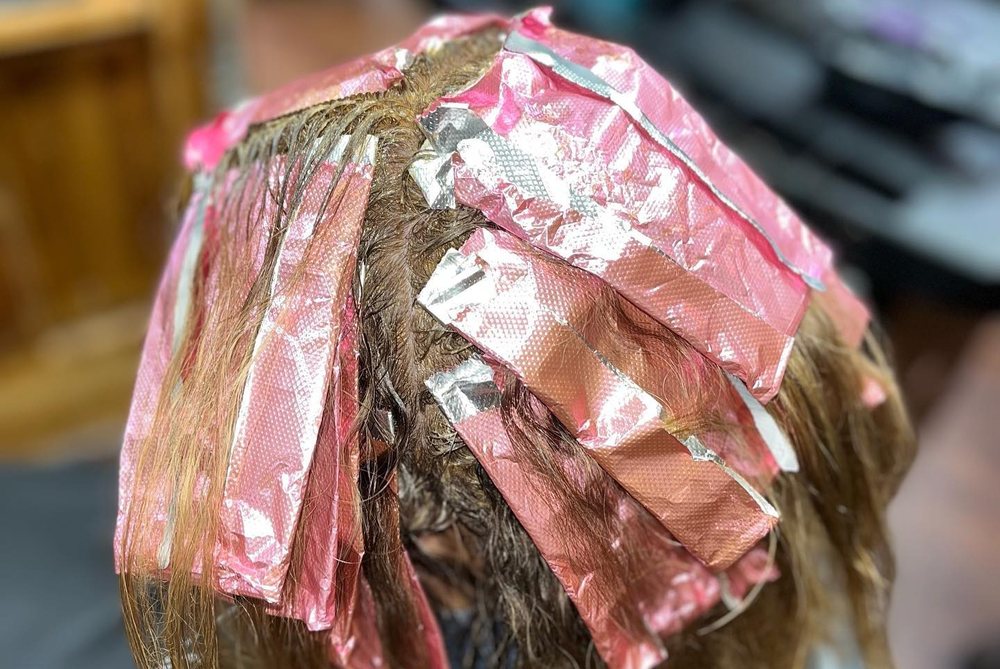 Pink foils through a guest's highlights at Julia Grace Salon.